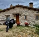 BMW R1250 GS Adventure in front of a rustic house in Italy